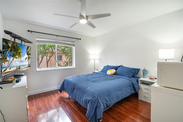 bedroom featuring baseboards, ceiling fan, and wood finished floors
