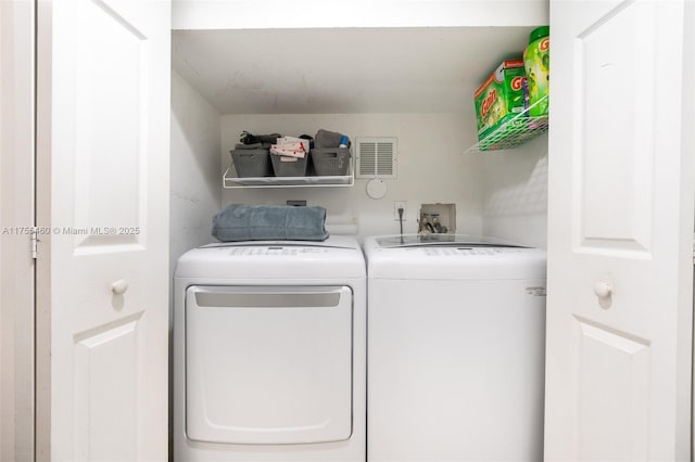 laundry room with washing machine and dryer, laundry area, and visible vents