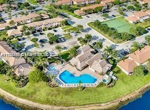 drone / aerial view featuring a residential view and a water view