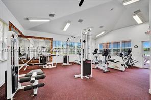 gym featuring vaulted ceiling
