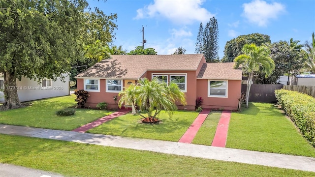 530 NE 110th Ter, Miami, FL 33161 - view of front of property featuring a front yard, stucco siding, and fence