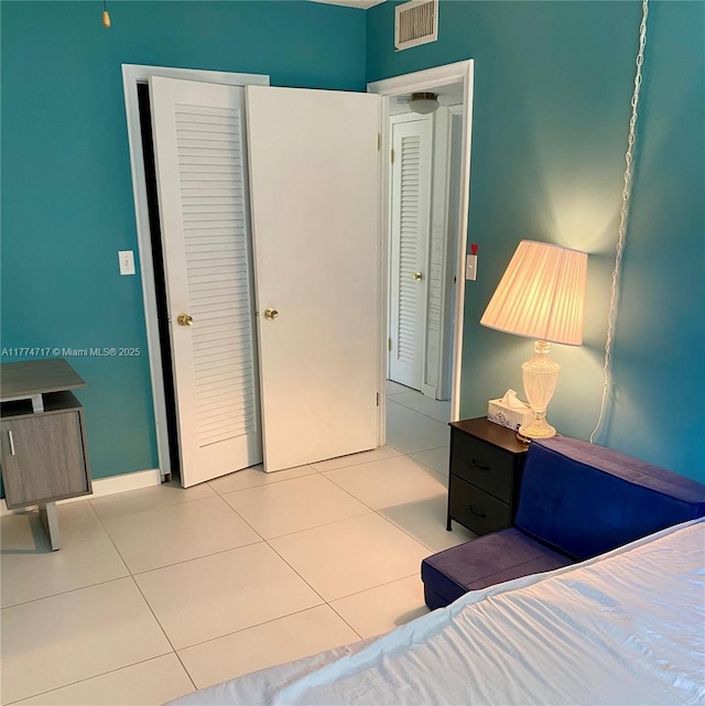 610 NE 12th Ave Unit 308, Hallandale Beach, FL 33009 - bedroom featuring baseboards, visible vents, and tile patterned flooring