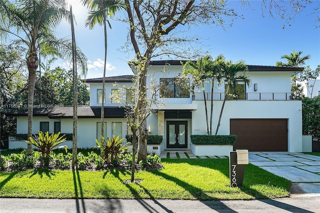 7360 SW 53rd Pl, Miami, FL 33143 - contemporary home with a front yard, french doors, stucco siding, a balcony, and a garage