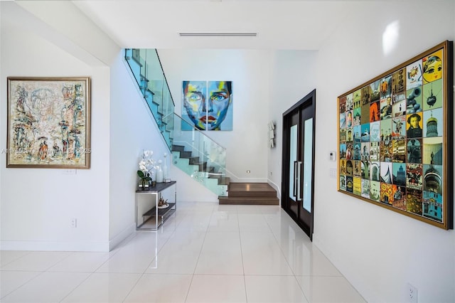 7360 SW 53rd Pl, Miami, FL 33143 - hall with french doors, tile patterned flooring, baseboards, and stairway