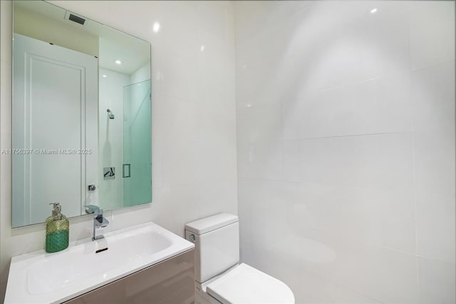 7360 SW 53rd Pl, Miami, FL 33143 - bathroom with tile walls, visible vents, toilet, vanity, and a walk in shower