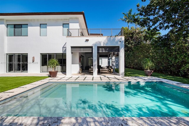 7360 SW 53rd Pl, Miami, FL 33143 - rear view of property with a patio area, stucco siding, a balcony, an outdoor hangout area, and an outdoor pool