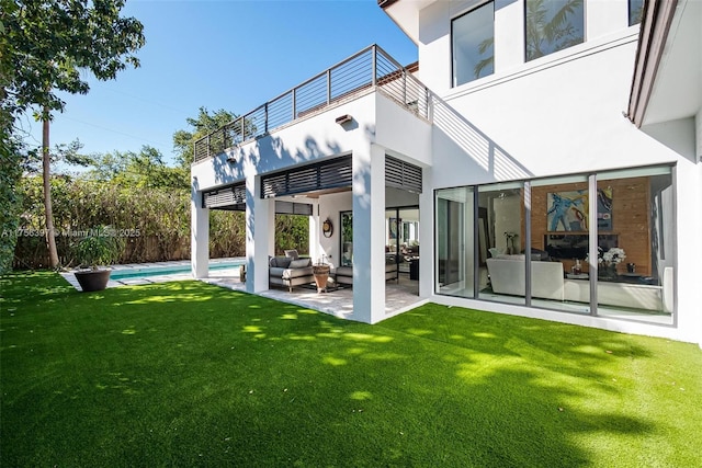7360 SW 53rd Pl, Miami, FL 33143 - back of property with a balcony, a patio, a fenced in pool, stucco siding, and a lawn