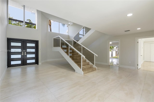413 Santurce Ave, Coral Gables, FL 33143 - foyer with visible vents, baseboards, a wealth of natural light, and stairs