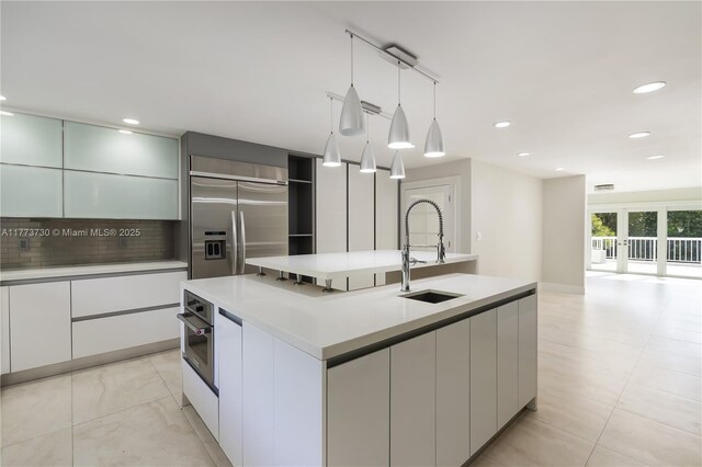 413 Santurce Ave, Coral Gables, FL 33143 - kitchen featuring a sink, light countertops, appliances with stainless steel finishes, and modern cabinets