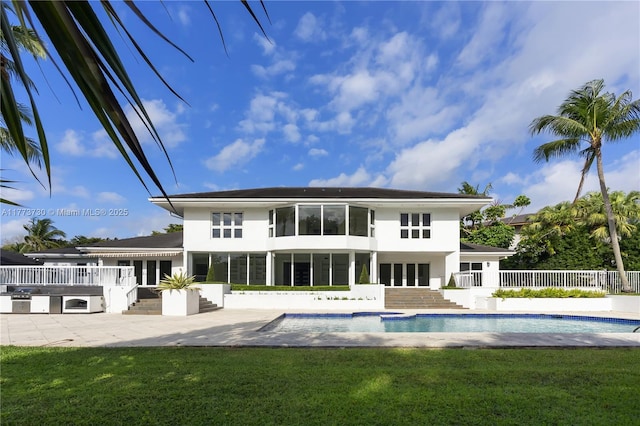 413 Santurce Ave, Coral Gables, FL 33143 - rear view of house featuring a fenced in pool, a patio area, fence, and a lawn