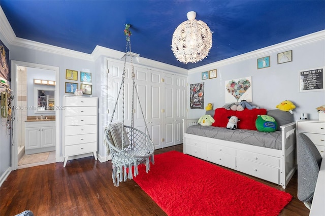 bedroom featuring an inviting chandelier, ornamental molding, ensuite bath, and wood finished floors