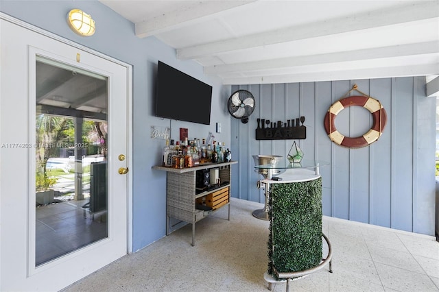 bar with a dry bar and beam ceiling