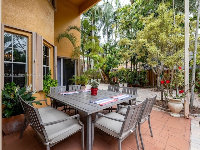 view of patio featuring outdoor dining area and fence