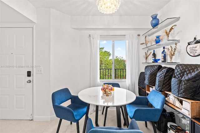 901 SW 141st Ave Unit 409M, Pembroke Pines, FL 33027 - dining area with light tile patterned floors, a chandelier, and baseboards