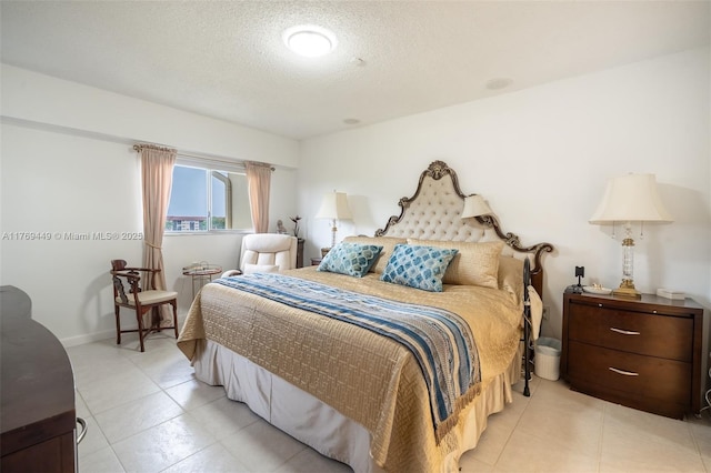 901 SW 141st Ave Unit 409M, Pembroke Pines, FL 33027 - bedroom featuring light tile patterned flooring, a textured ceiling, and baseboards