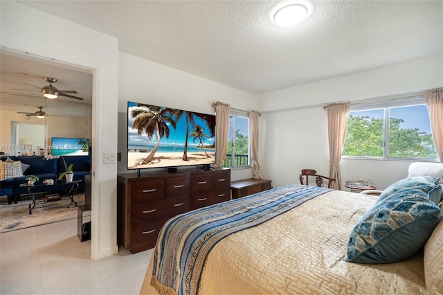 901 SW 141st Ave Unit 409M, Pembroke Pines, FL 33027 - bedroom with a textured ceiling and light tile patterned flooring