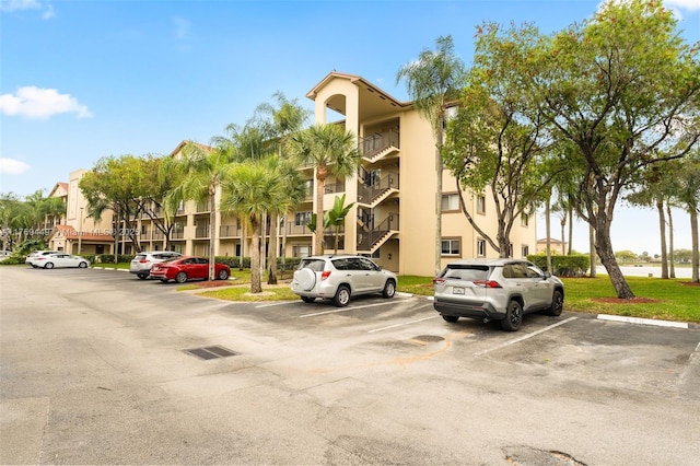 901 SW 141st Ave Unit 409M, Pembroke Pines, FL 33027 - view of building exterior with uncovered parking