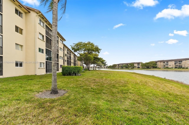 901 SW 141st Ave Unit 409M, Pembroke Pines, FL 33027 - surrounding community with a water view and a yard