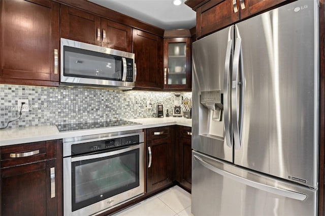kitchen with light countertops, backsplash, and stainless steel appliances