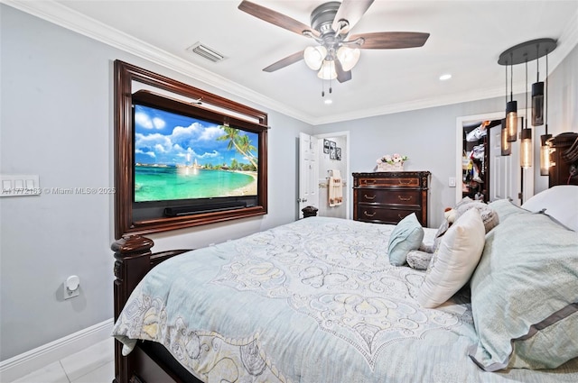 bedroom featuring ornamental molding, visible vents, a spacious closet, and baseboards