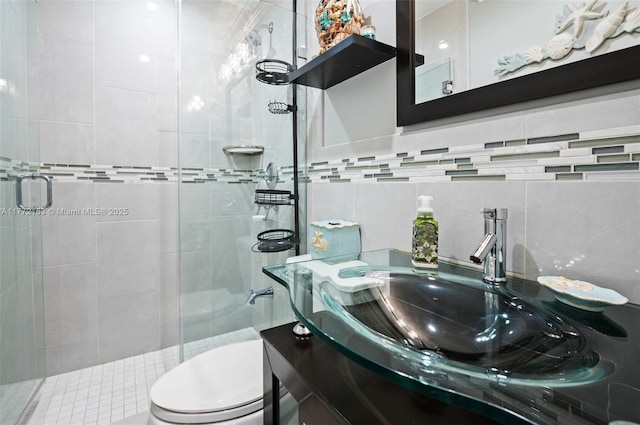 full bath featuring tasteful backsplash, toilet, a stall shower, and vanity