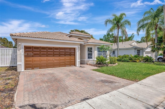 16249 NW 24th St, Pembroke Pines, FL 33028 - mediterranean / spanish-style home with decorative driveway, stucco siding, a front yard, a garage, and a tiled roof