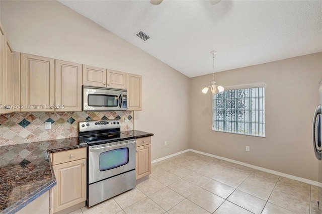 16249 NW 24th St, Pembroke Pines, FL 33028 - kitchen featuring appliances with stainless steel finishes, decorative backsplash, vaulted ceiling, light tile patterned floors, and a textured ceiling