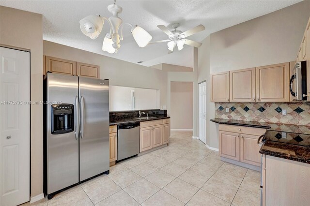 16249 NW 24th St, Pembroke Pines, FL 33028 - kitchen featuring appliances with stainless steel finishes, backsplash, light tile patterned floors, light brown cabinetry, and a textured ceiling