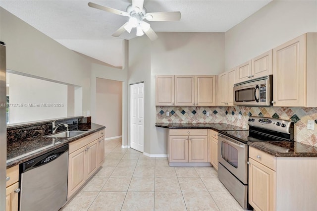 16249 NW 24th St, Pembroke Pines, FL 33028 - kitchen with appliances with stainless steel finishes, lofted ceiling, backsplash, light brown cabinetry, and dark stone countertops