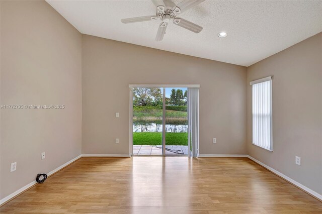 16249 NW 24th St, Pembroke Pines, FL 33028 - empty room featuring healthy amount of natural light, light wood-style flooring, a textured ceiling, lofted ceiling, and recessed lighting