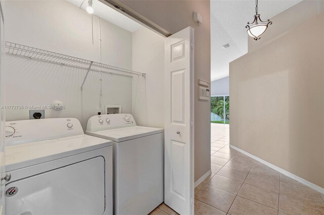 16249 NW 24th St, Pembroke Pines, FL 33028 - washroom with washer and clothes dryer and light tile patterned floors