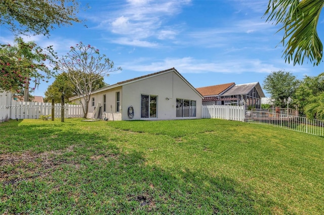 16249 NW 24th St, Pembroke Pines, FL 33028 - back of house featuring stucco siding, a fenced backyard, and a sunroom