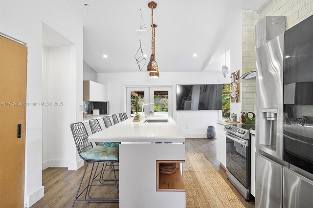 266 NE 117th St, Miami, FL 33161 - kitchen featuring lofted ceiling, a sink, french doors, and appliances with stainless steel finishes