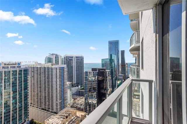 balcony featuring a water view and a view of city