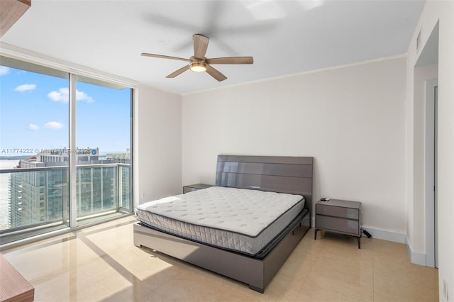 bedroom with expansive windows, light tile patterned floors, ornamental molding, baseboards, and ceiling fan
