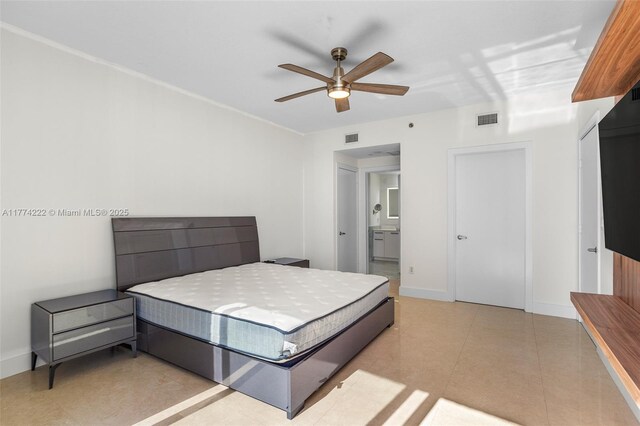 tiled bedroom with ensuite bathroom, baseboards, and visible vents