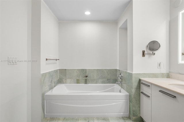 full bathroom featuring vanity and a garden tub