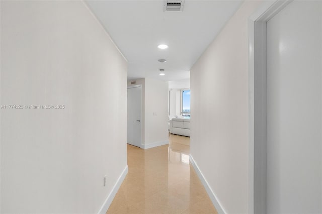 corridor featuring light tile patterned floors, recessed lighting, baseboards, and visible vents