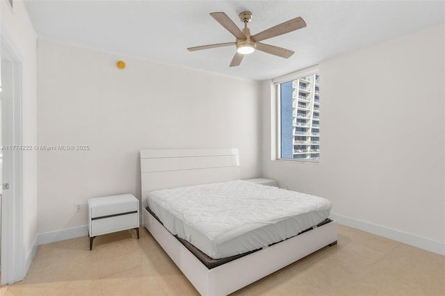 bedroom featuring light tile patterned flooring, baseboards, and ceiling fan