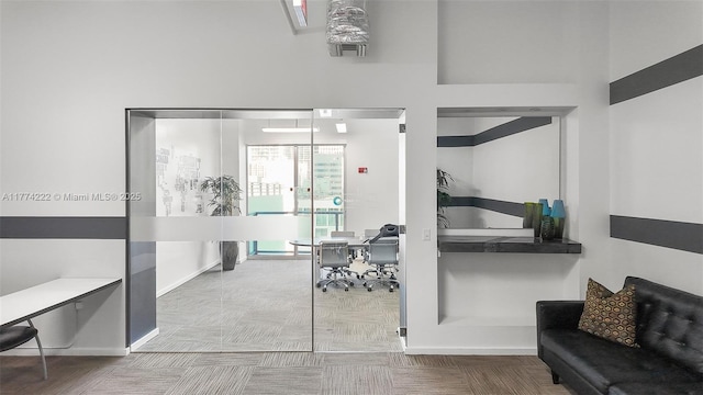 interior space with baseboards and carpet floors