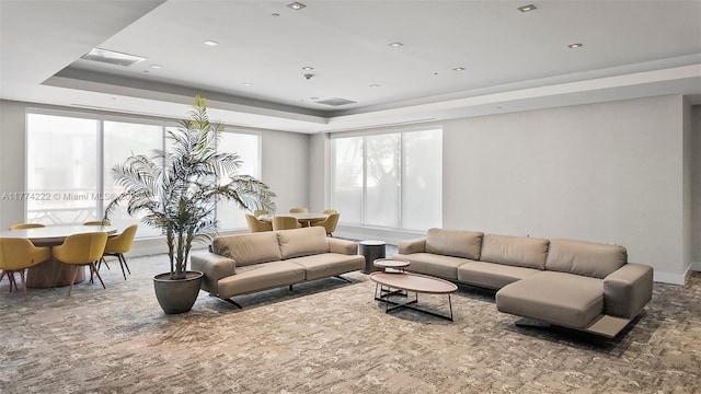 living room with visible vents and a raised ceiling