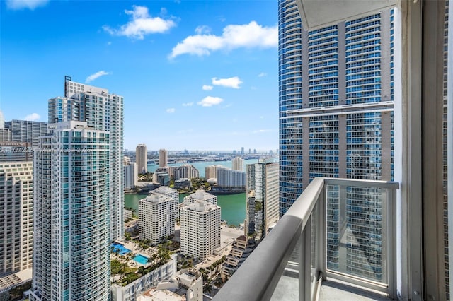 balcony with a water view and a city view