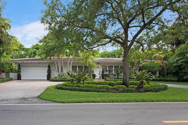 1523 Blue Rd, Coral Gables, FL 33146 - view of front facade featuring a garage, decorative driveway, and stucco siding
