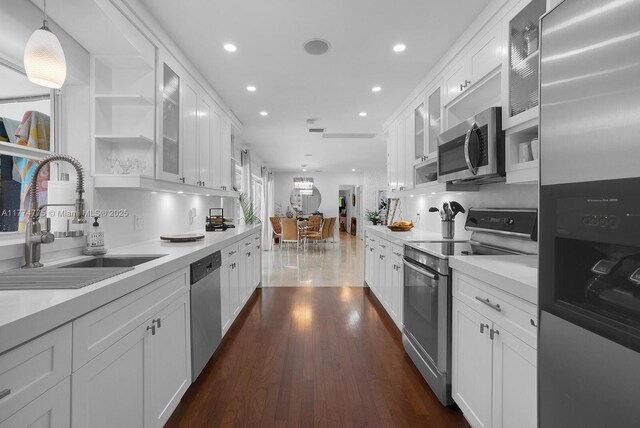 1523 Blue Rd, Coral Gables, FL 33146 - kitchen featuring stainless steel appliances, a sink, white cabinets, light countertops, and recessed lighting