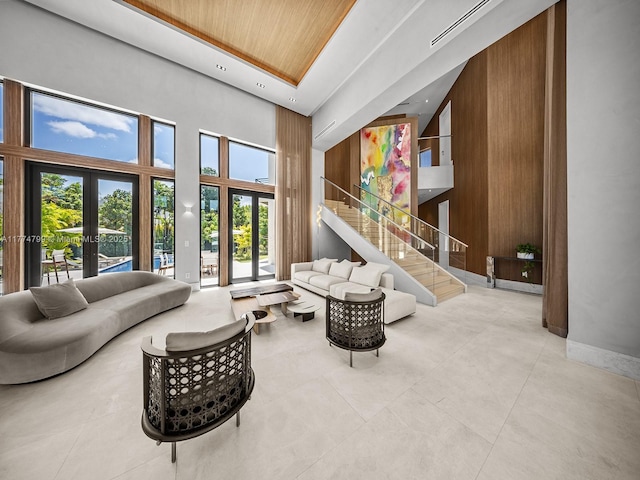 5700 SW 91st St, Pinecrest, FL 33156 - living room with wood ceiling, a high ceiling, stairs, french doors, and baseboards