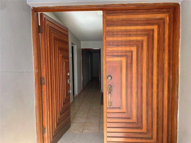 corridor with light tile patterned floors