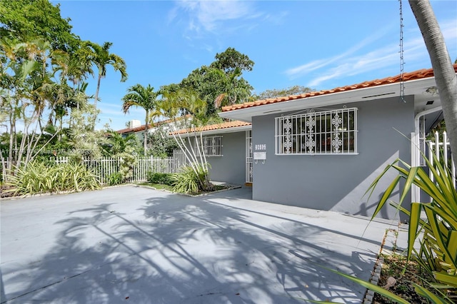 1645 SW 10th St, Miami, FL 33135 - mediterranean / spanish-style house featuring stucco siding, a tiled roof, and a patio area