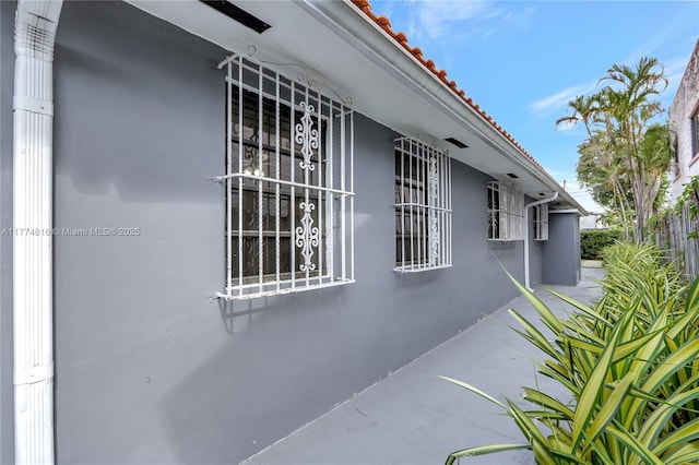 view of home's exterior featuring a tiled roof and stucco siding