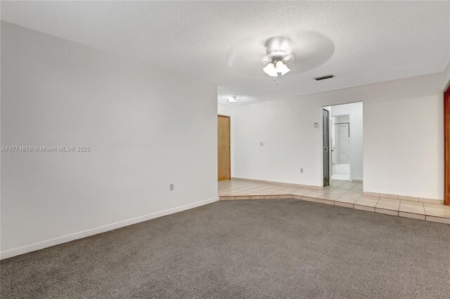 carpeted empty room featuring baseboards and ceiling fan