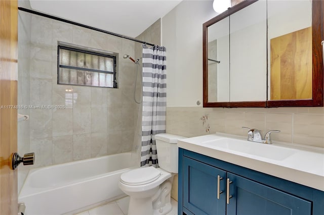 bathroom with tile walls, shower / bath combo with shower curtain, toilet, tile patterned floors, and vanity